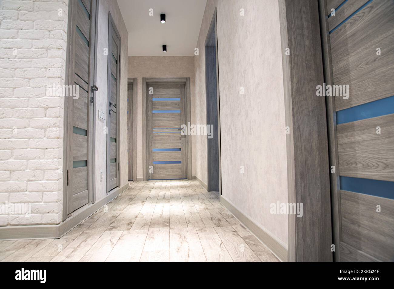 Modern corridor in an apartment after renovation in gray tones. Gray ... - Industrial Apartment Renovations With Led Lighting