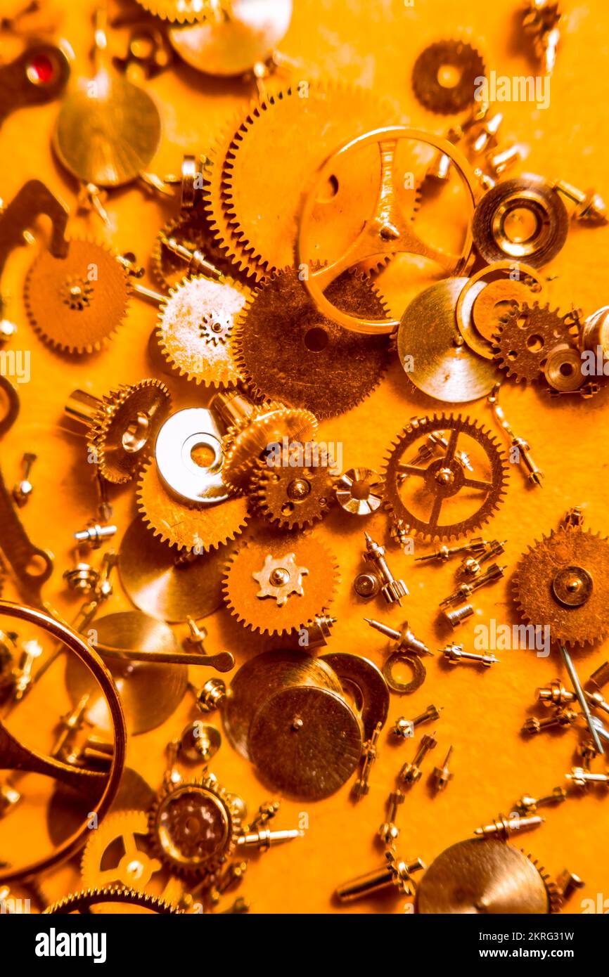 Intricate macro photography on a deconstruct of watch parts and engineering mechanics. Clockwork orange Stock Photo
