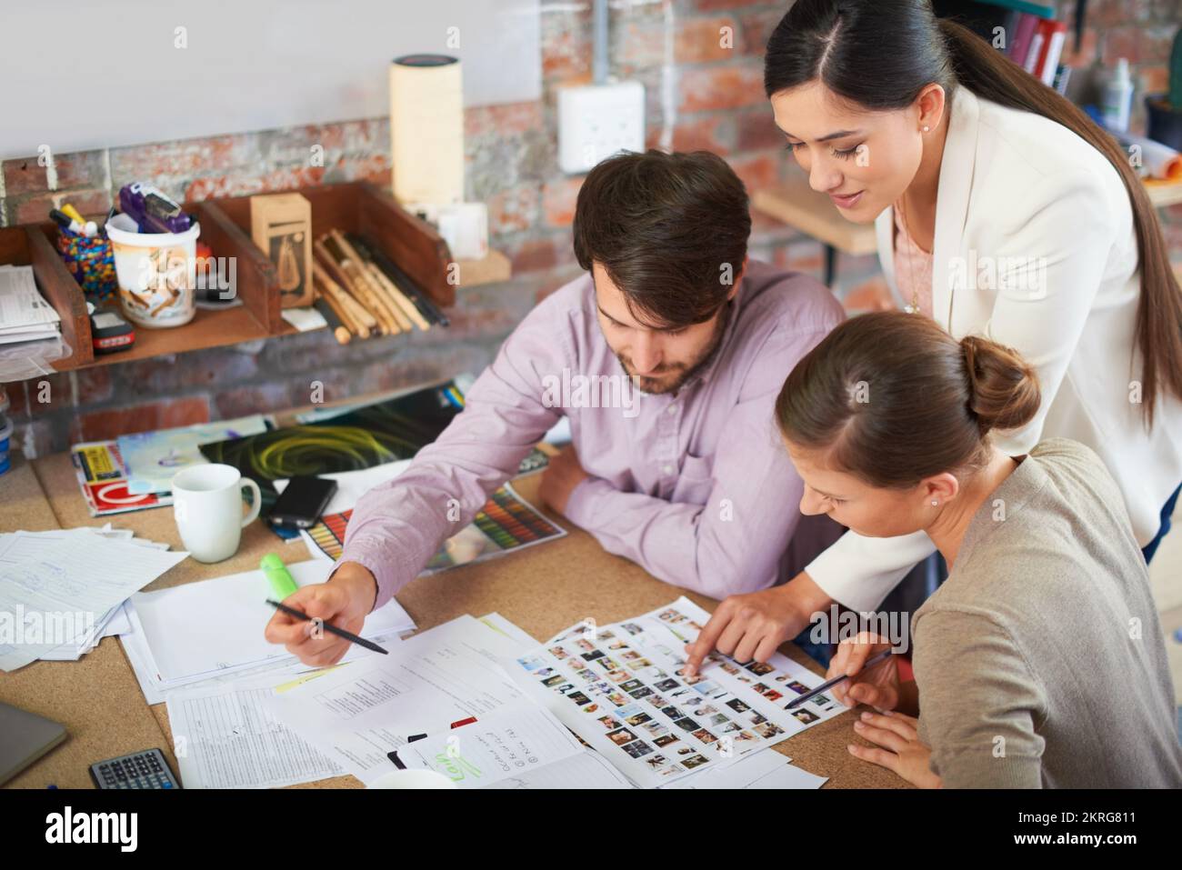Working on their next campaigne. Young creative professionals working in an office. Stock Photo