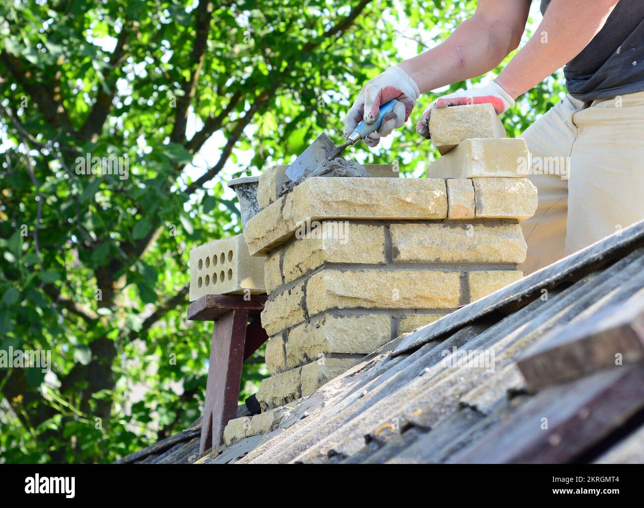 Repairing a brick chimney with bricklaying. Building contractor is