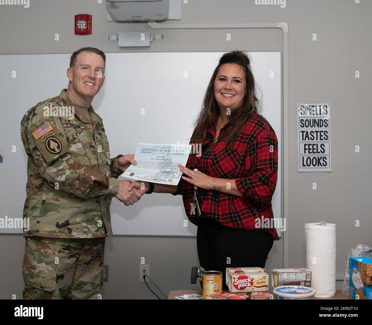Network Enterprise Technology Command (NETCOM) Commanding General, Maj. Gen. Christopher L. Eubank, presents Colonel Johnston Elementary teacher, Leanne Barnhill, with a certificate of achievement Nov. 16. The awards were presented to give thanks to the school faculty for their recent Veterans Day event. Stock Photo