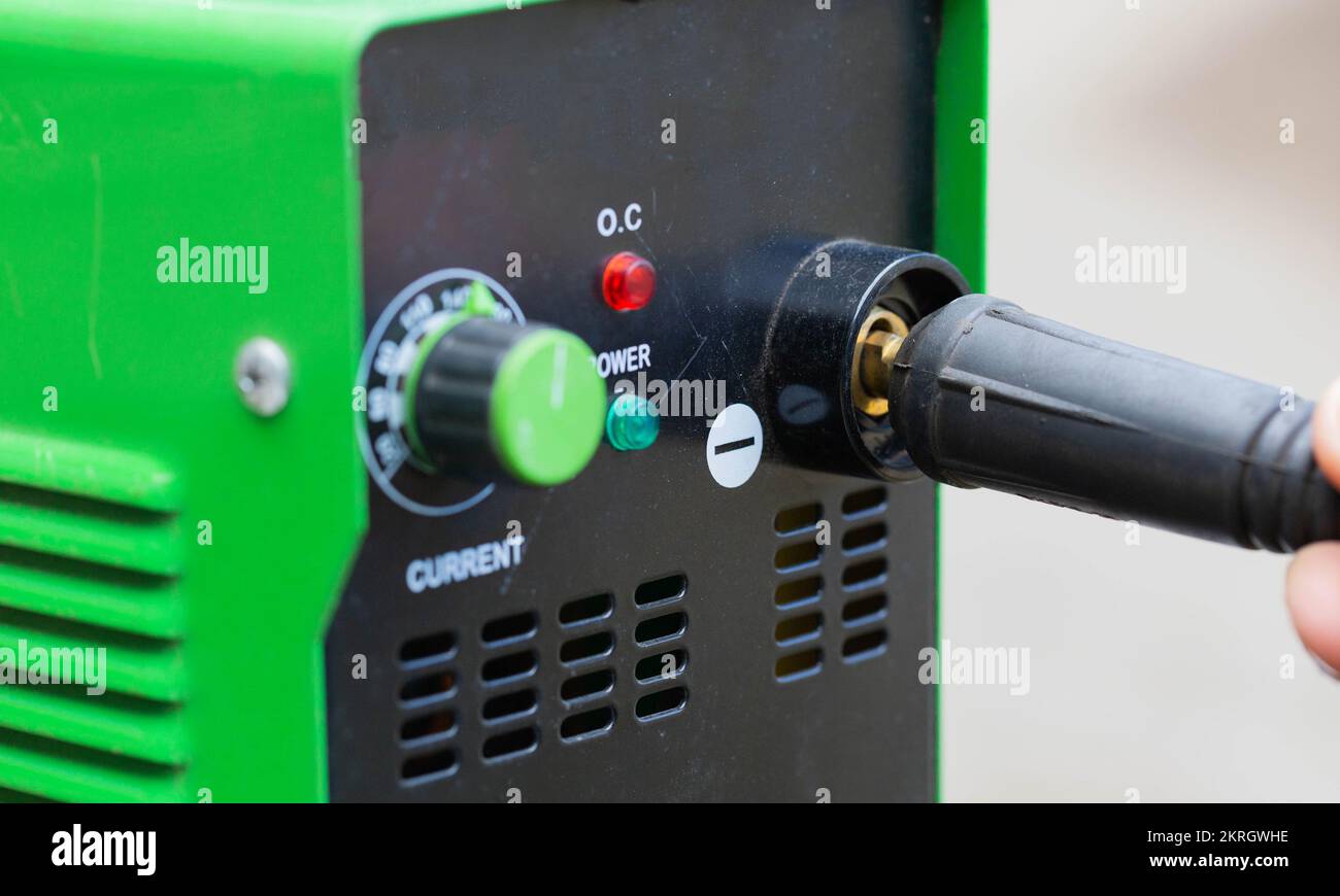 Adjusting the current strength on a modern welding machine. Welding arc
