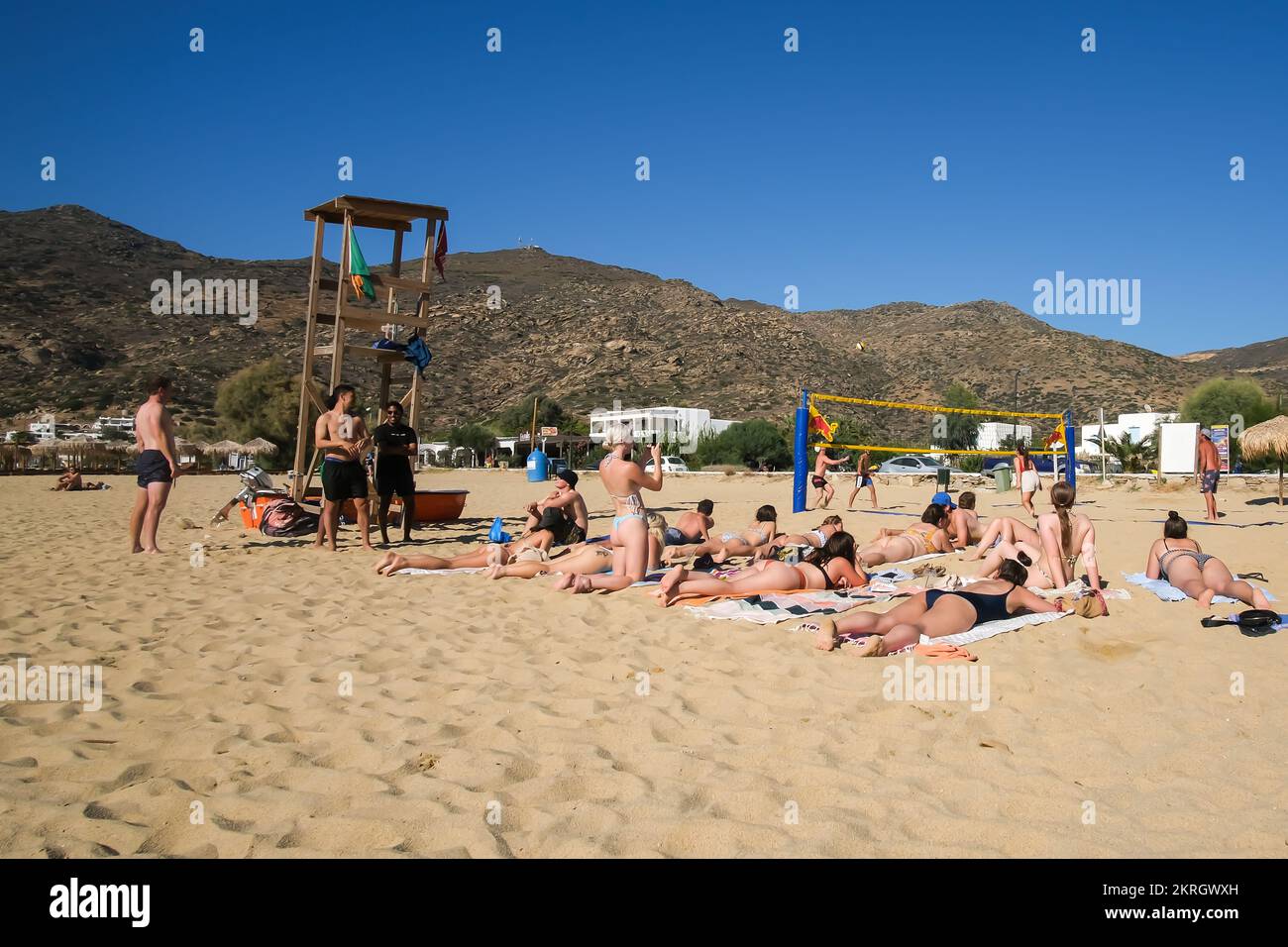 Ios, Greece - September 15, 2022 : Young tourists playing volley ball and enjoying the wonderful sandy Mylopotas beach in Ios Greece Stock Photo