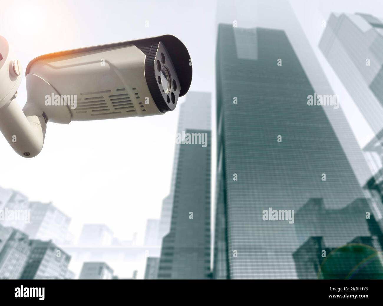 City security concept, CCTV camera in front of high tech business skyscrapers Stock Photo