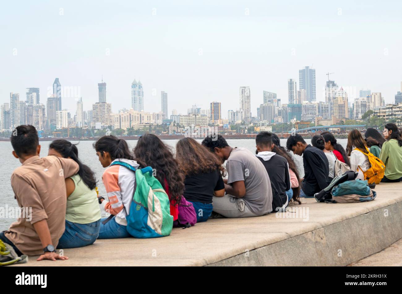 MUMBAI - SEPTEMBER 25: People sitting along the Marine Drive or Queens Necklace promenade in Mumbai on September 25. 2022 in India Stock Photo