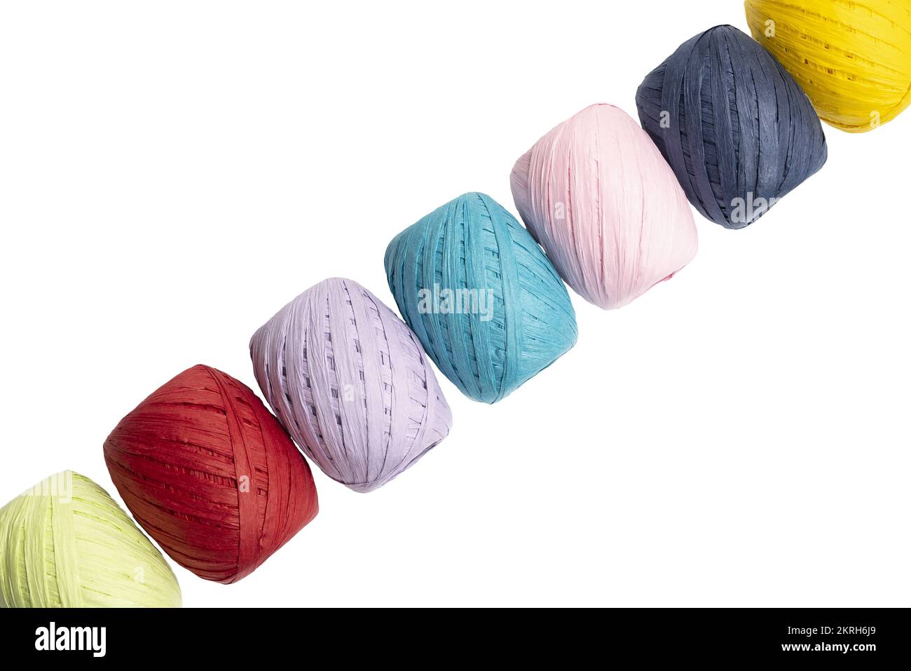 some balls of colored raffia on a transparent surface Stock Photo