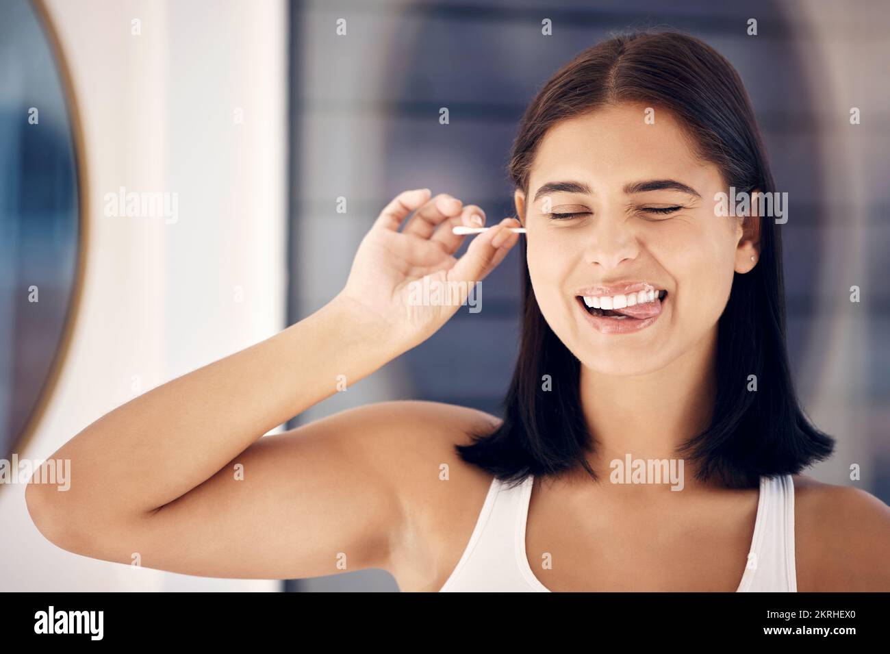 Cotton bud, woman and cleaning ear in bathroom for self care. Personal