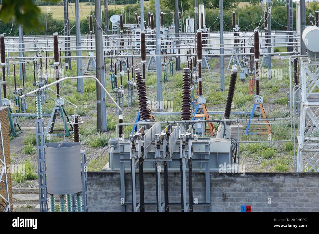 High voltage electricity power distribution plant and electricity pillars with ceramic insulator. Stock Photo
