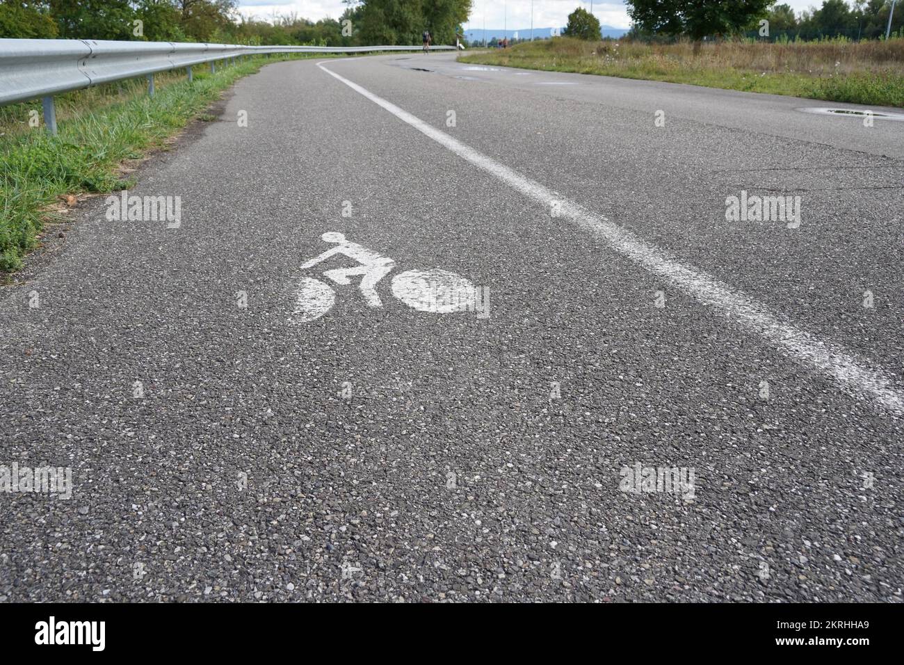 Bike lane or cycle path along the car road in the vicinity of hydroelectric power plant Kembs in France. Stock Photo