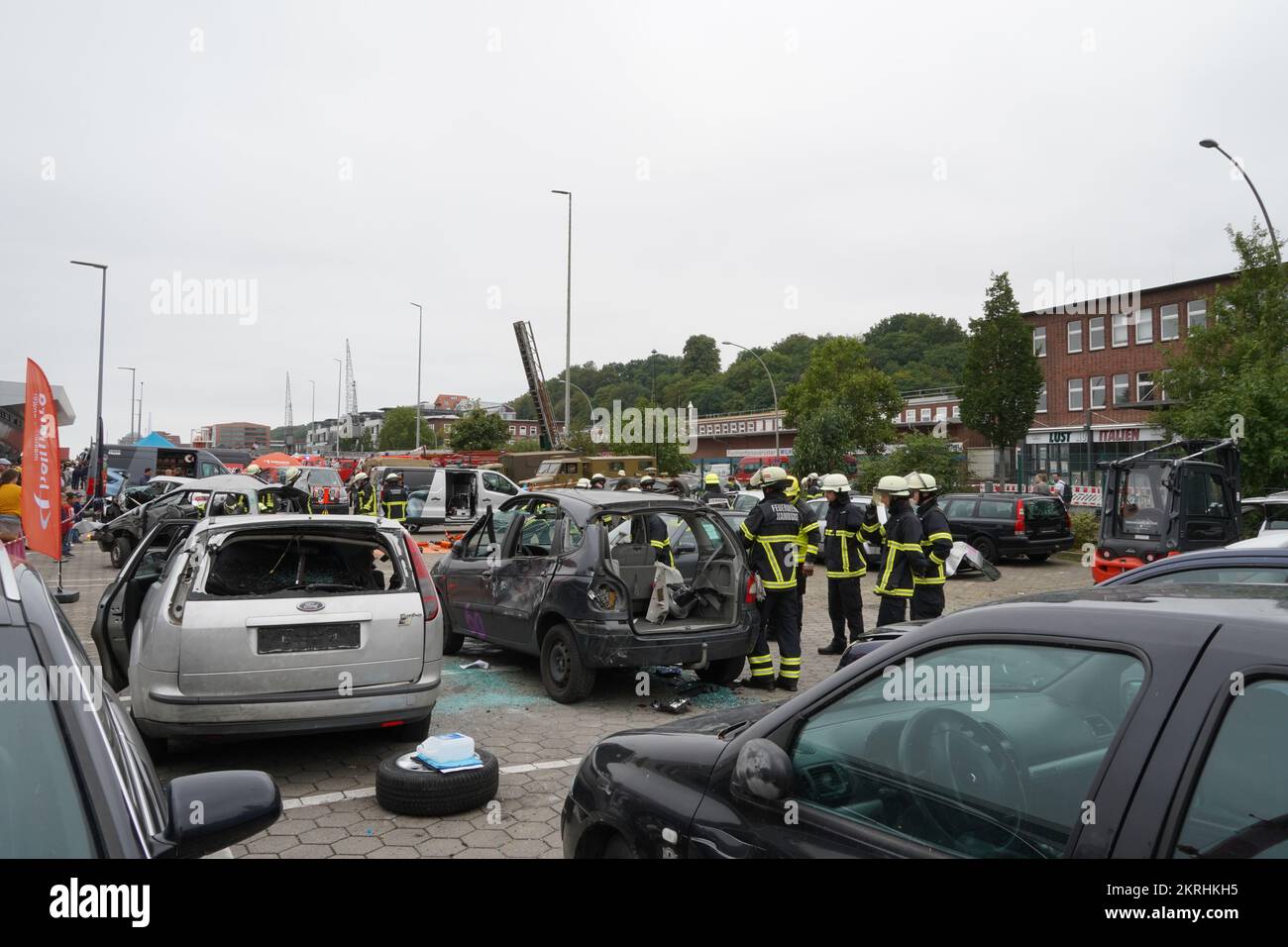 Firemen demonstrate how to extinguish fire of the crashed cars during traffic accident. Stock Photo