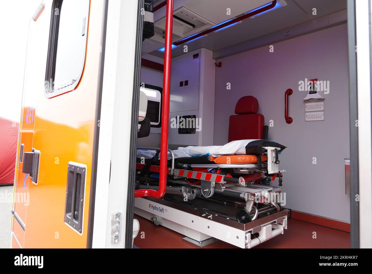 View through open side door of the orange ambulance car. Inside are