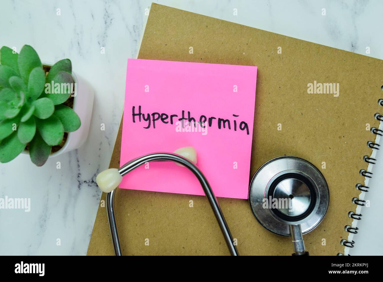 Concept of Hyperthermia write on sticky notes isolated on Wooden Table. Stock Photo