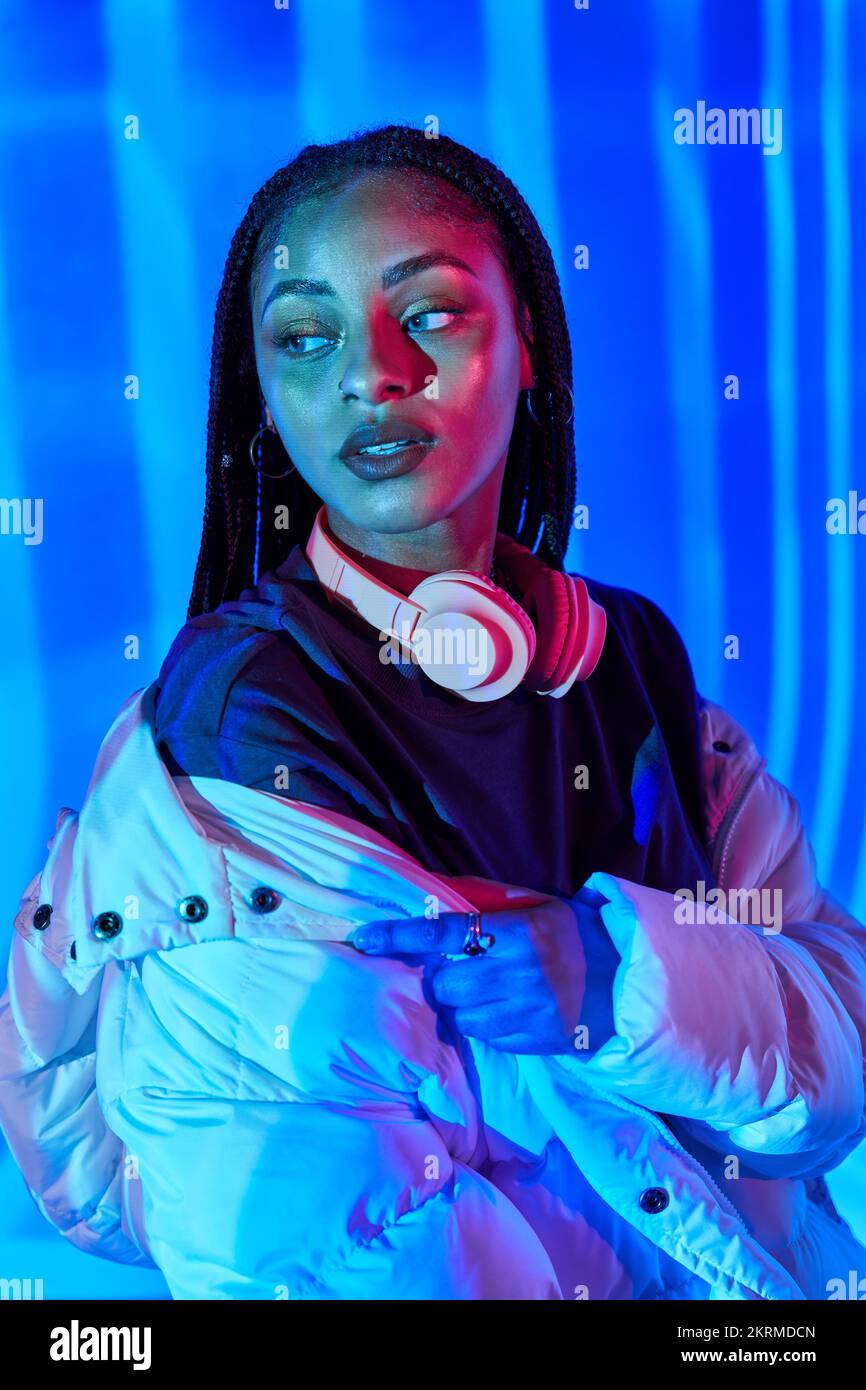 Cool young African American female model with long dark braids in warm ...