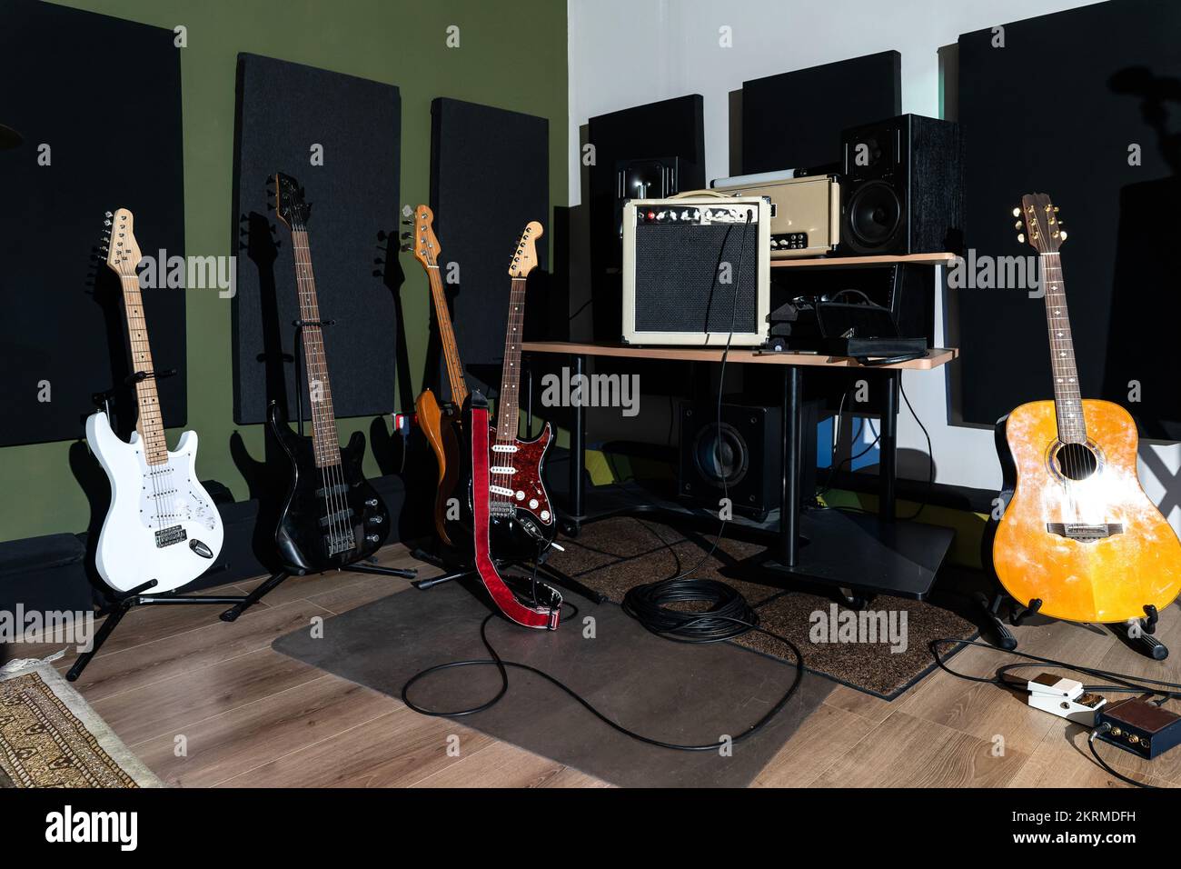 Contemporary music studio with electric and acoustic guitars placed on