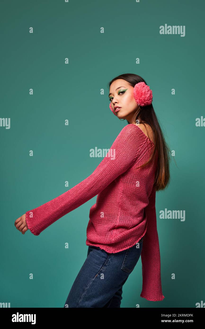 Portrait side view of young Filipino female model in stylish outfit and