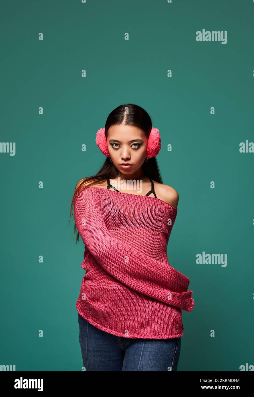 Portrait of young Filipino female model in stylish outfit and earmuffs