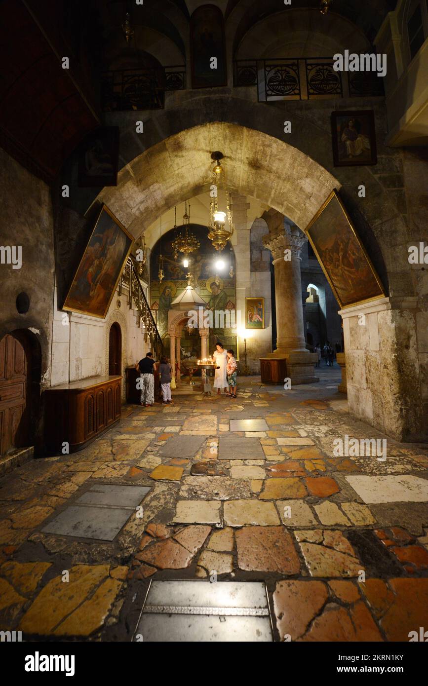 A woman lighting candles inside the church of the holy Sepulchre in the