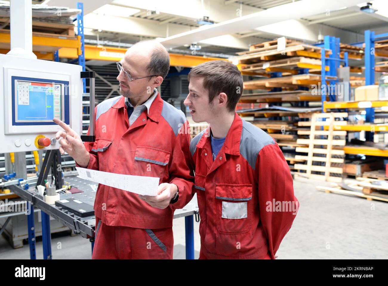 Vocational training in metal construction - apprentice and skilled worker talking and learning - careers for young people in the industry Stock Photo