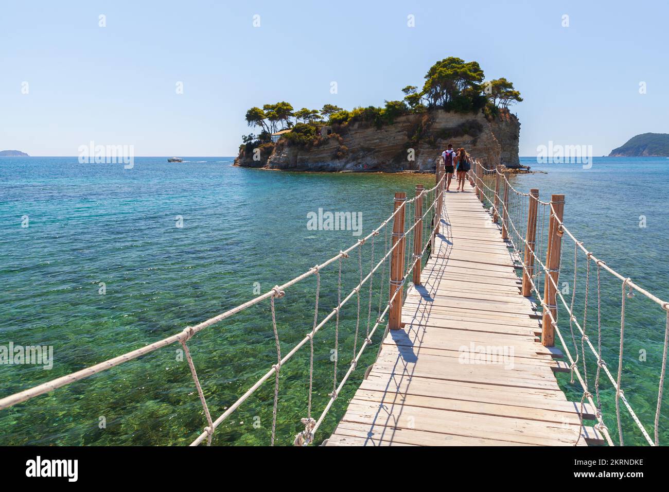Zakynthos, Greece - August 17, 2016: Tourists walk the Bridge to Cameo Island on a  sunny summer day Stock Photo