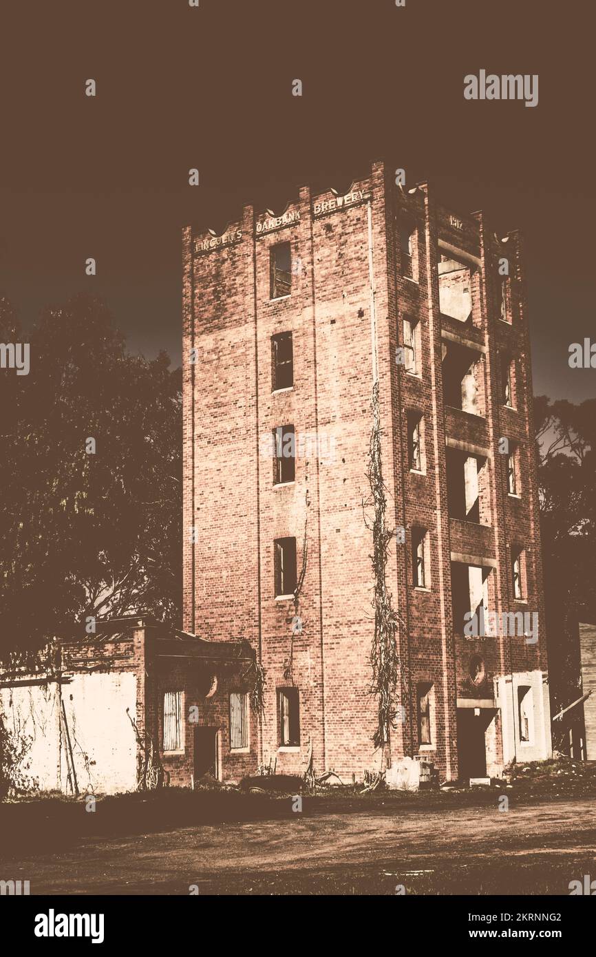 Urban destruction shown in an abandoned and ruined city building in washed out decay. Lincoln’s Oakbank Brewery, Narrandera, NSW, Australia Stock Photo