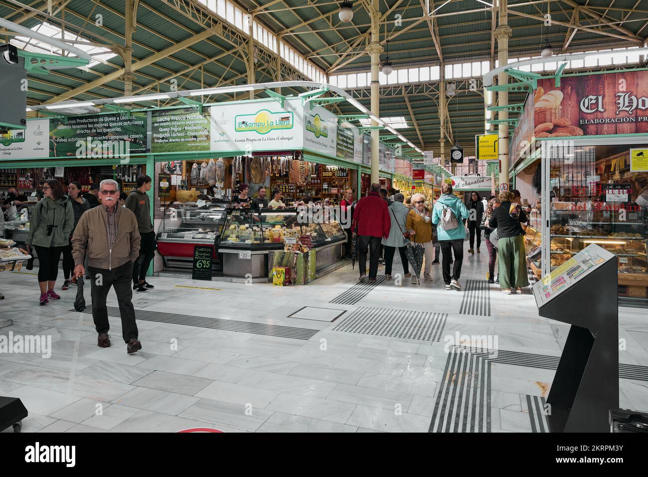 Oviedo, Spain - November 28, 2022: People entering and leaving the Oviedo municipal market in the concept of rising food prices due to inflation and Stock Photo