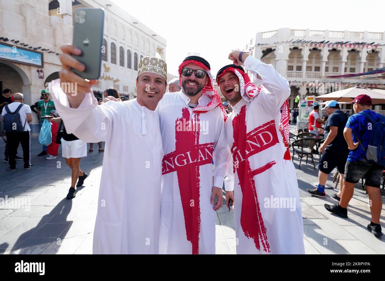 England fans pose for a photograph at a souq in Doha on the day of the FIFA World Cup Group B match between Wales and England. Picture date: Tuesday November 29, 2022. Stock Photo