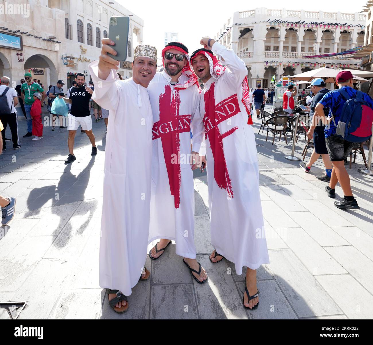 England fans pose for a photograph at a souq in Doha on the day of the FIFA World Cup Group B match between Wales and England. Picture date: Tuesday November 29, 2022. Stock Photo