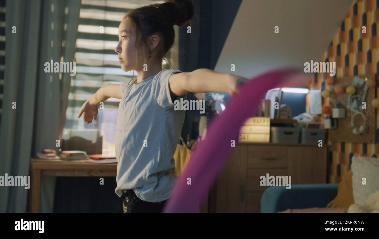 Woman in sportswear doing side leg split on a wall outdoors Stock