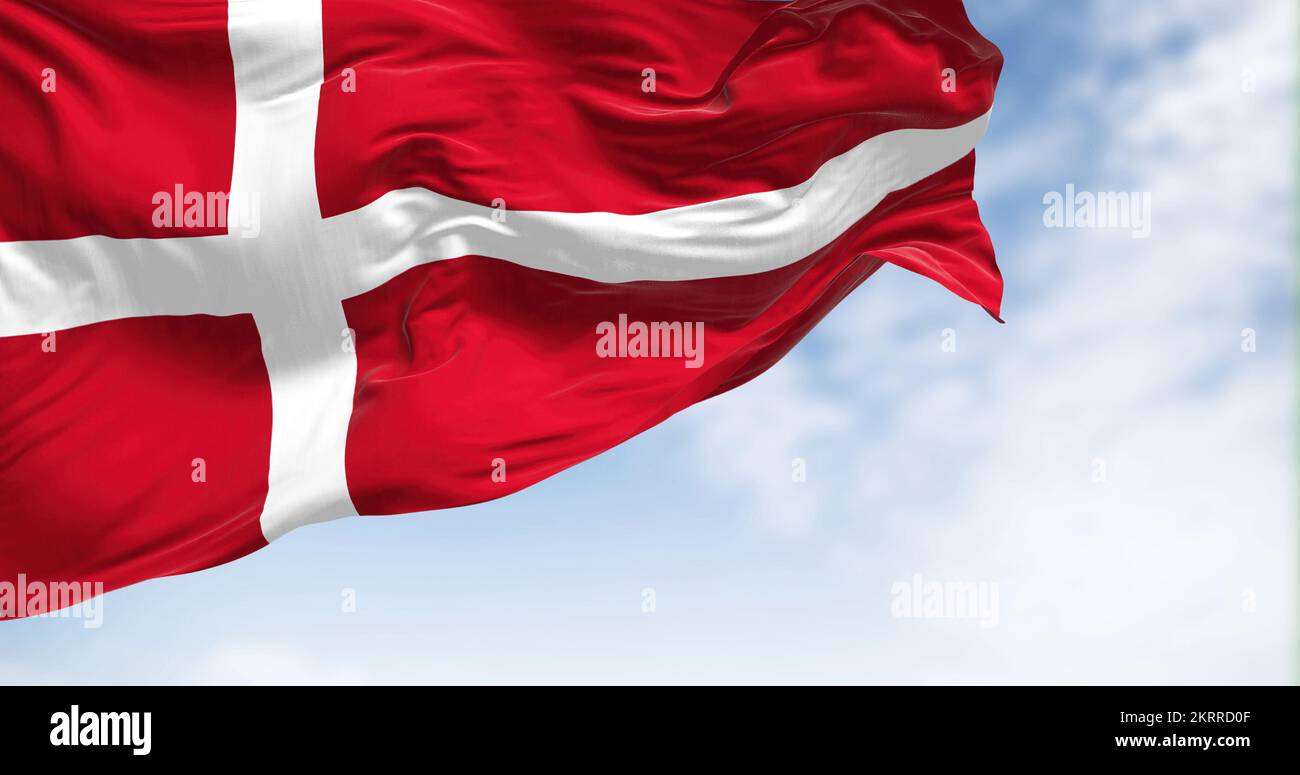 Close-up view of the Denmark national flag waving in the wind. The Kingdom of Denmark is a Nordic country in Northern Europe. Fabric textured backgrou Stock Photo