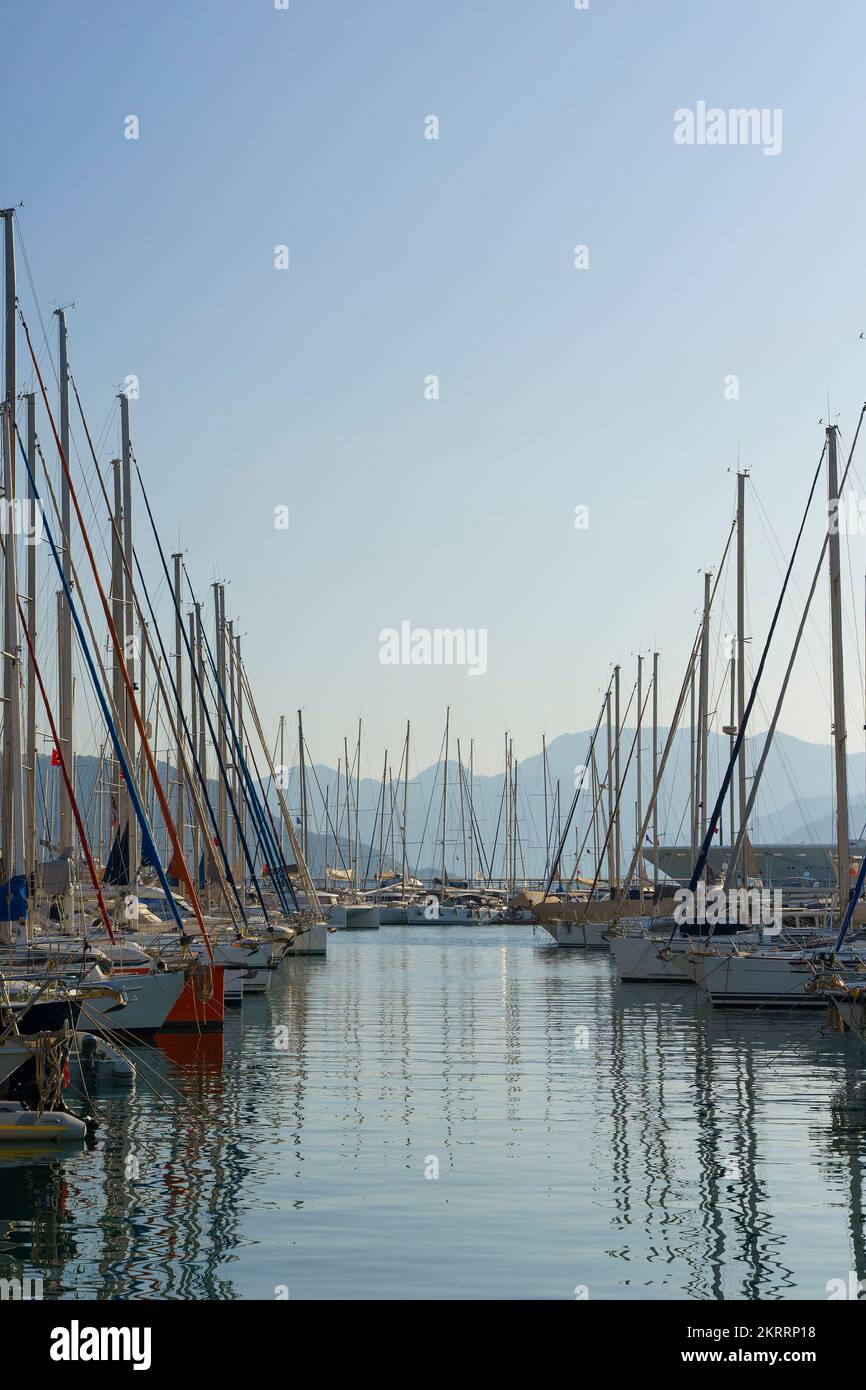 Pier with yachts. Many beautiful yachts with masts in the marina. Vacation, travel, luxury concept. High quality photo Stock Photo