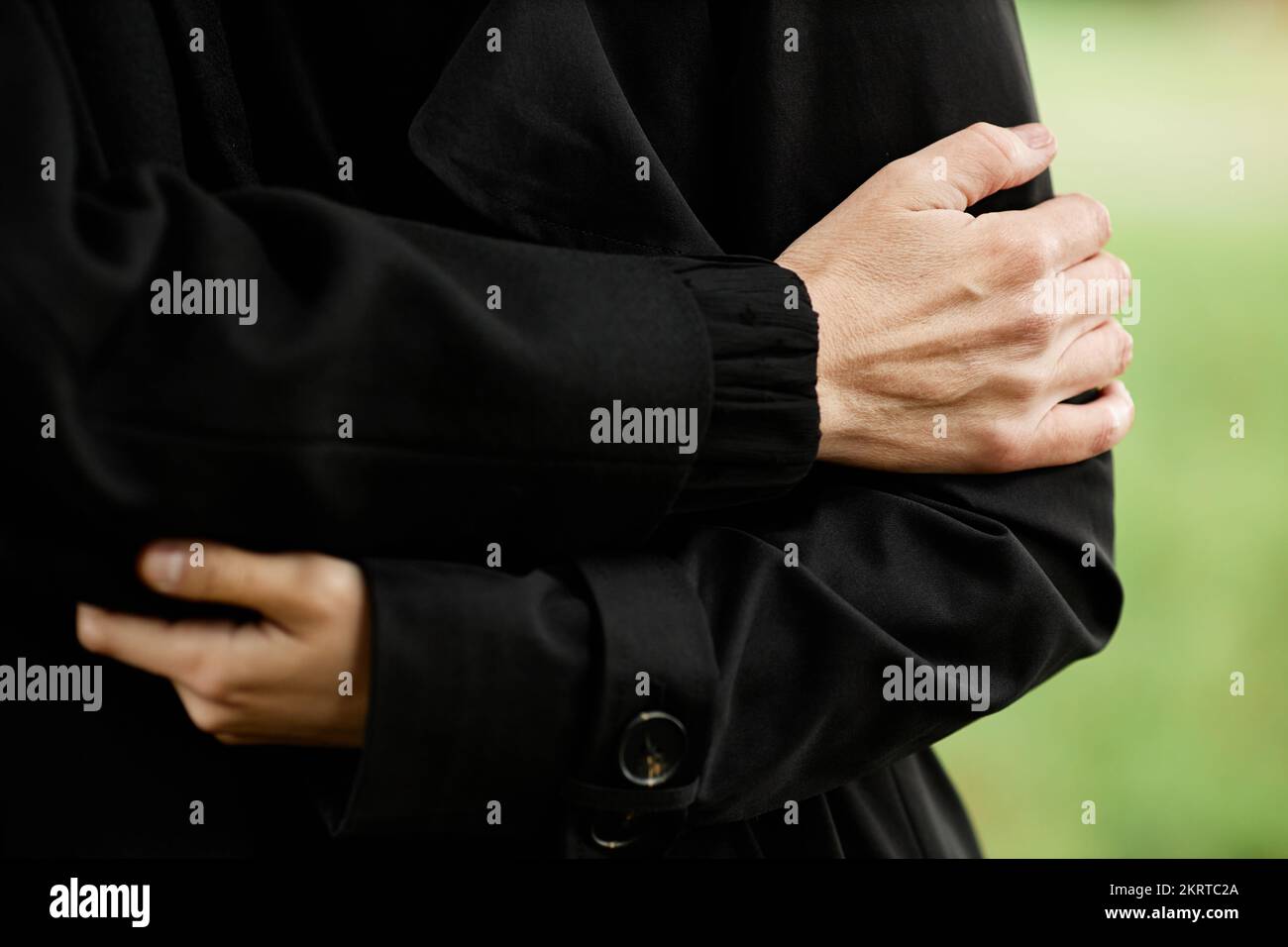 Close up of grieving woman wearing black at outdoor funeral ceremony, copy space Stock Photo
