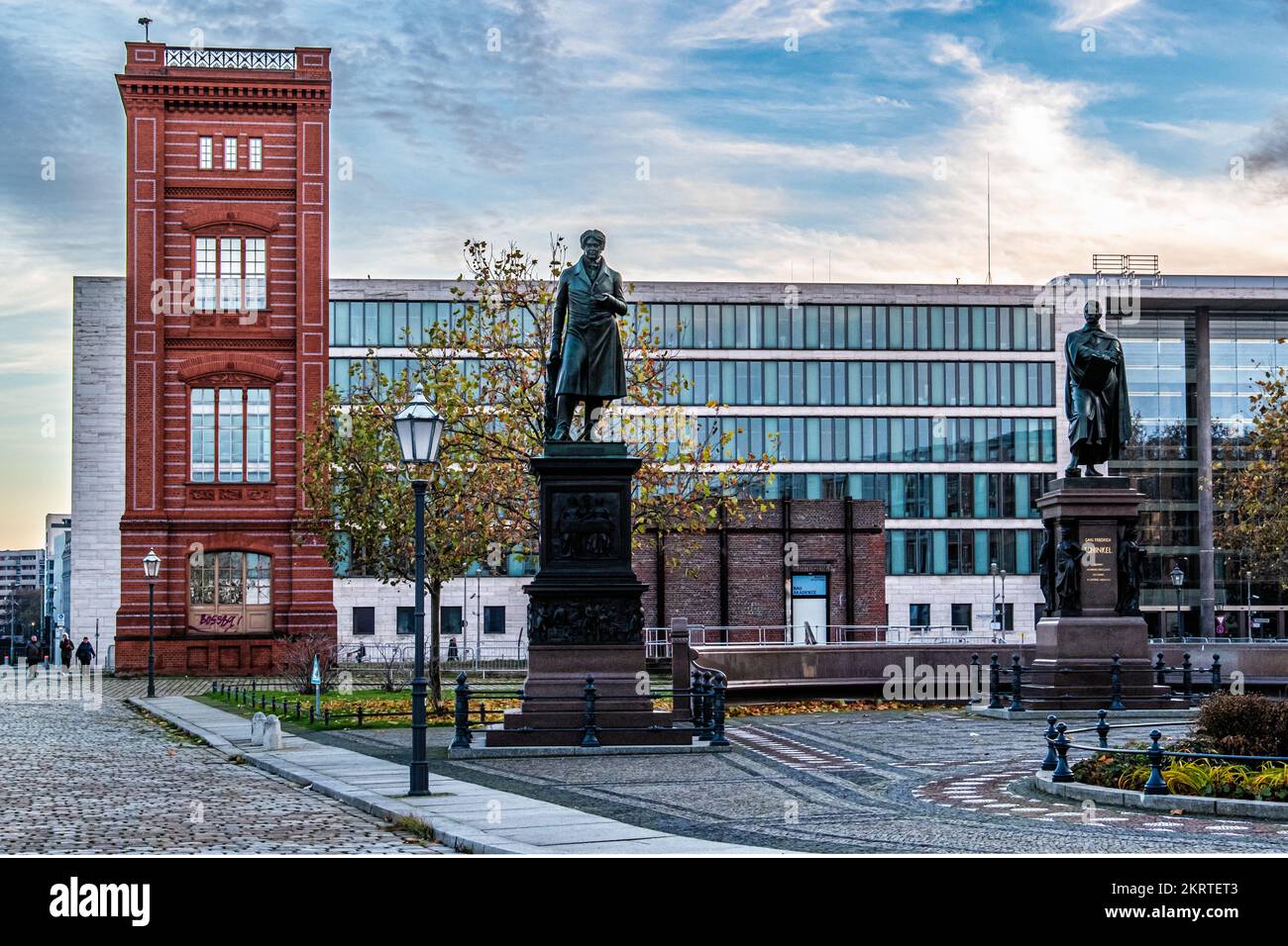 Schinkelplatz, Square with reconstructed corner of Bauakedemie façade & memorial statues of Karl Friedrich Schinkel & Peter Christian Wilhelm Beuth Stock Photo