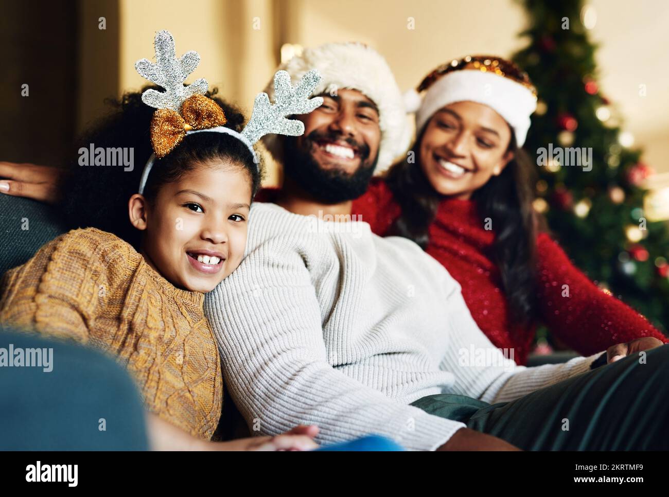 Happy family, christmas hat or bonding in house or home living room on celebration holiday, festive event or vacation. Portrait, smile or xmas girl Stock Photo