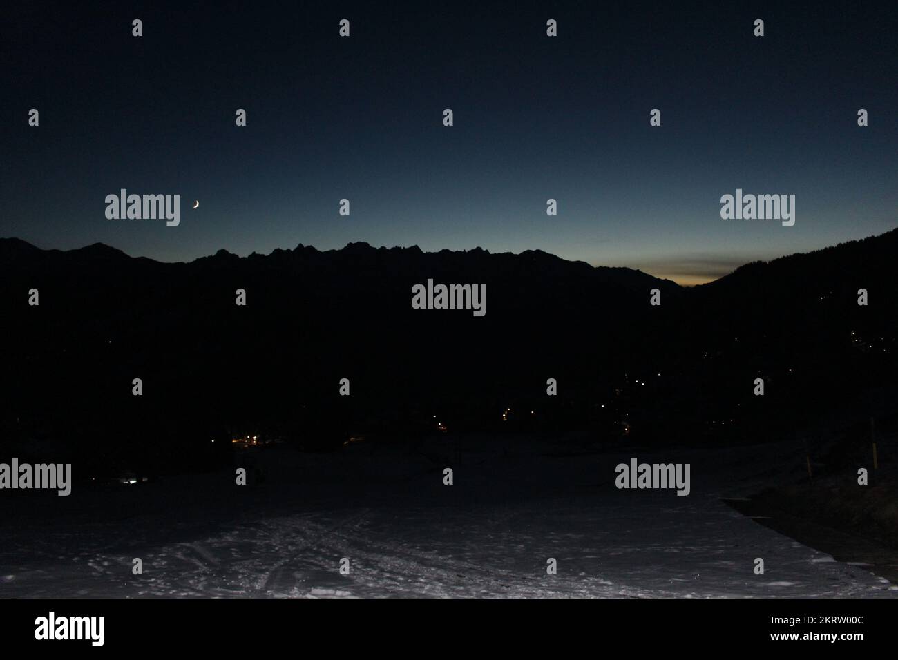 Blue hour twilight over the Swiss alps in Verbier, Canton Valais, Switzerland. Crescent moon