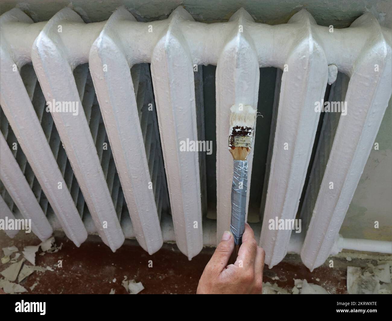white enamel painting of an antique iron radiator in a room top view