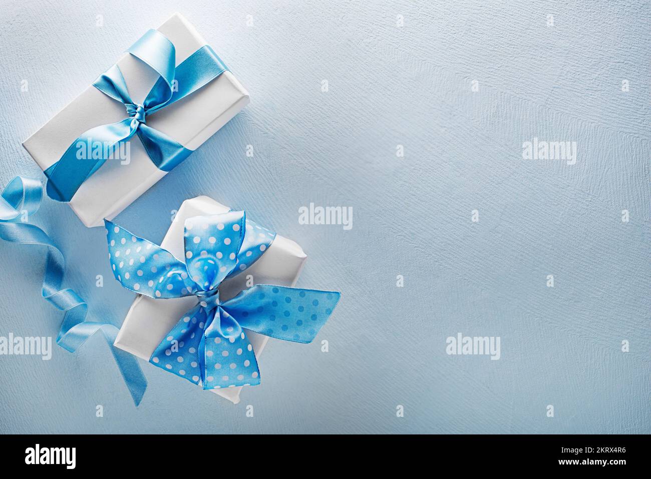 Holidays blue background with gift box. Top view with copy space Stock Photo