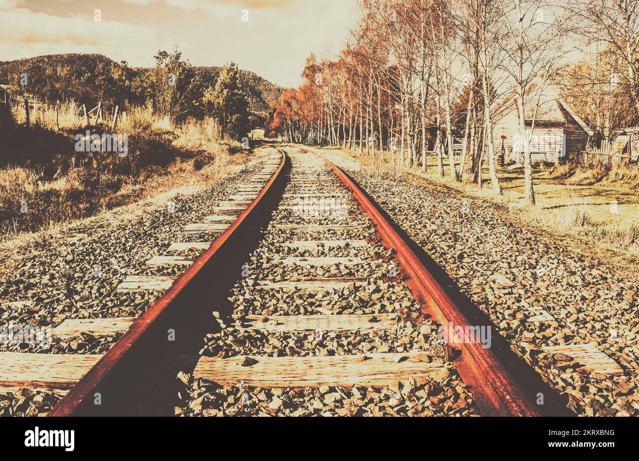 Shabby train tracks background on a washed out curve into landscaped transportation. New Norkfolk, Tasmania, Australia Stock Photo