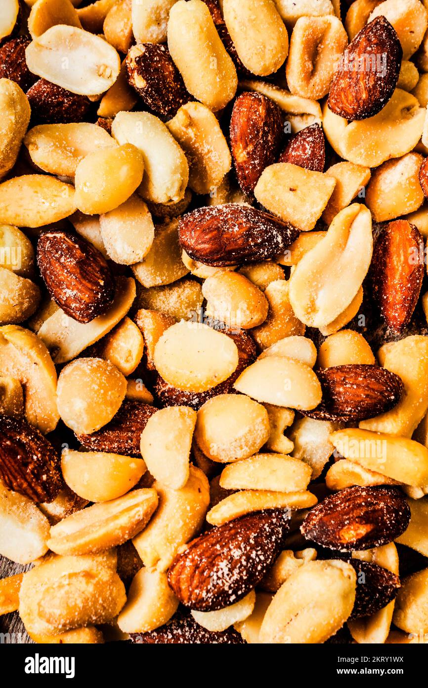 Full frame closeup image on a mix of salted nuts including almonds