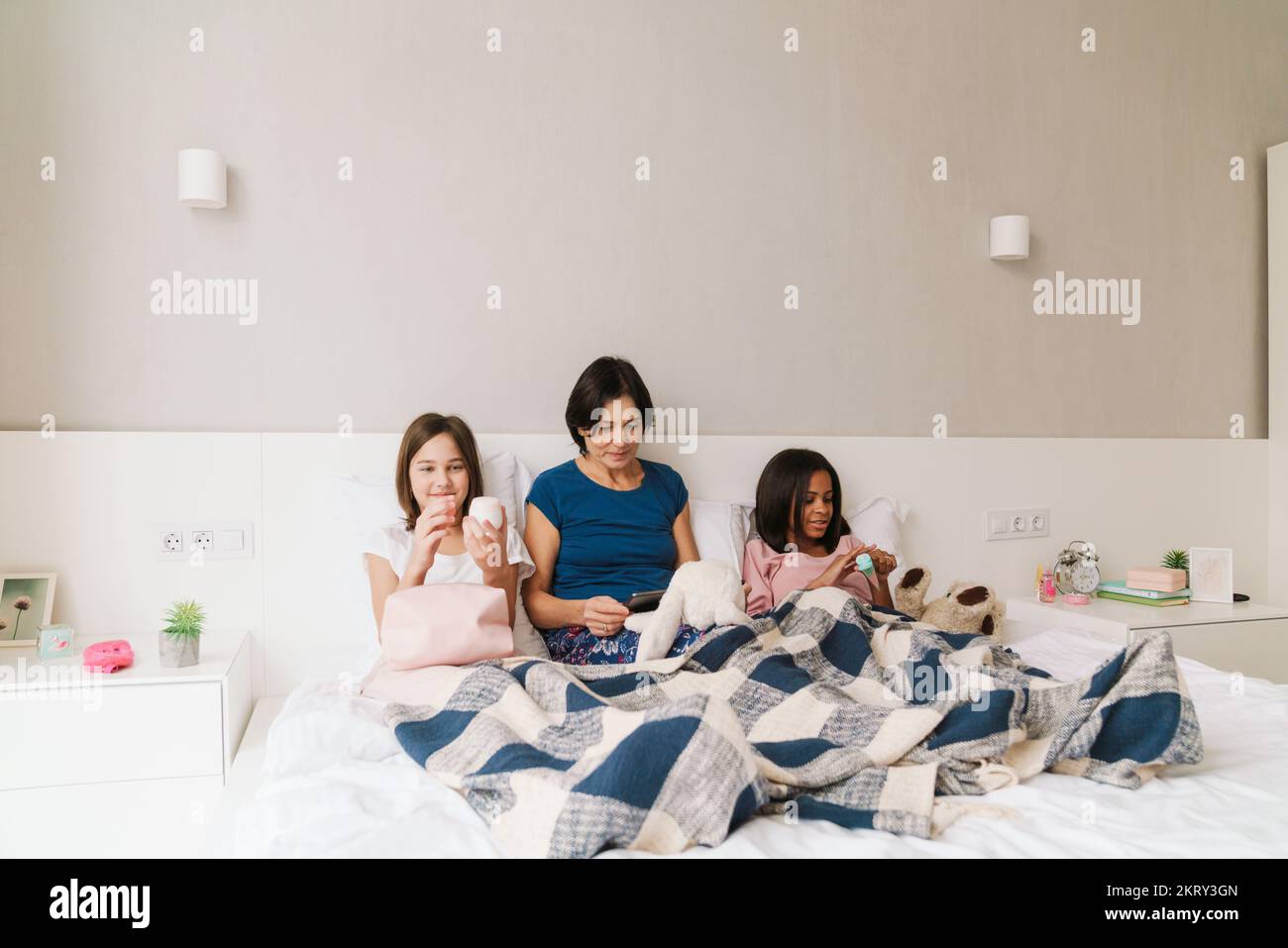 White woman and her daughters spending time together while resting on ...