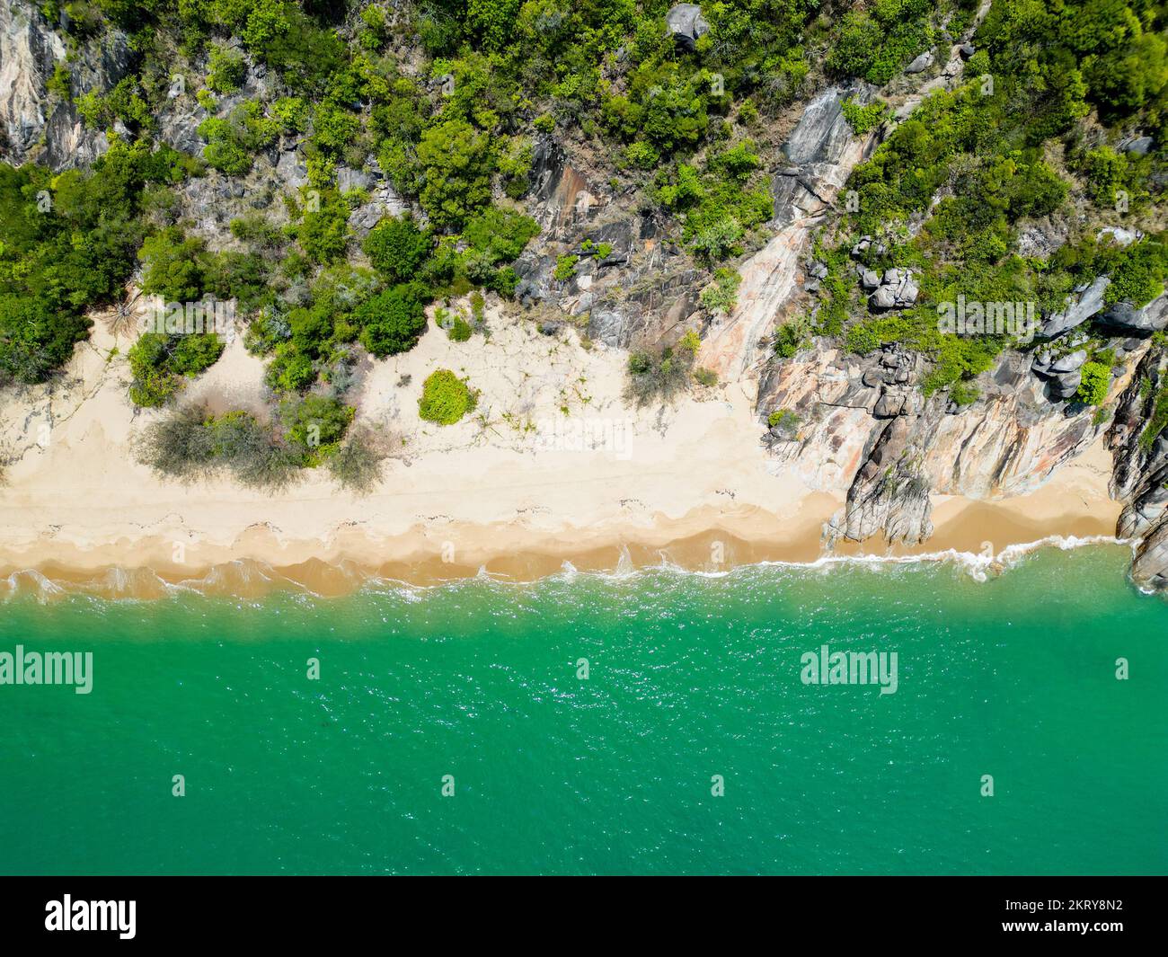 Aerial down shot of tropicl beach with waves crashing, white sand and ...