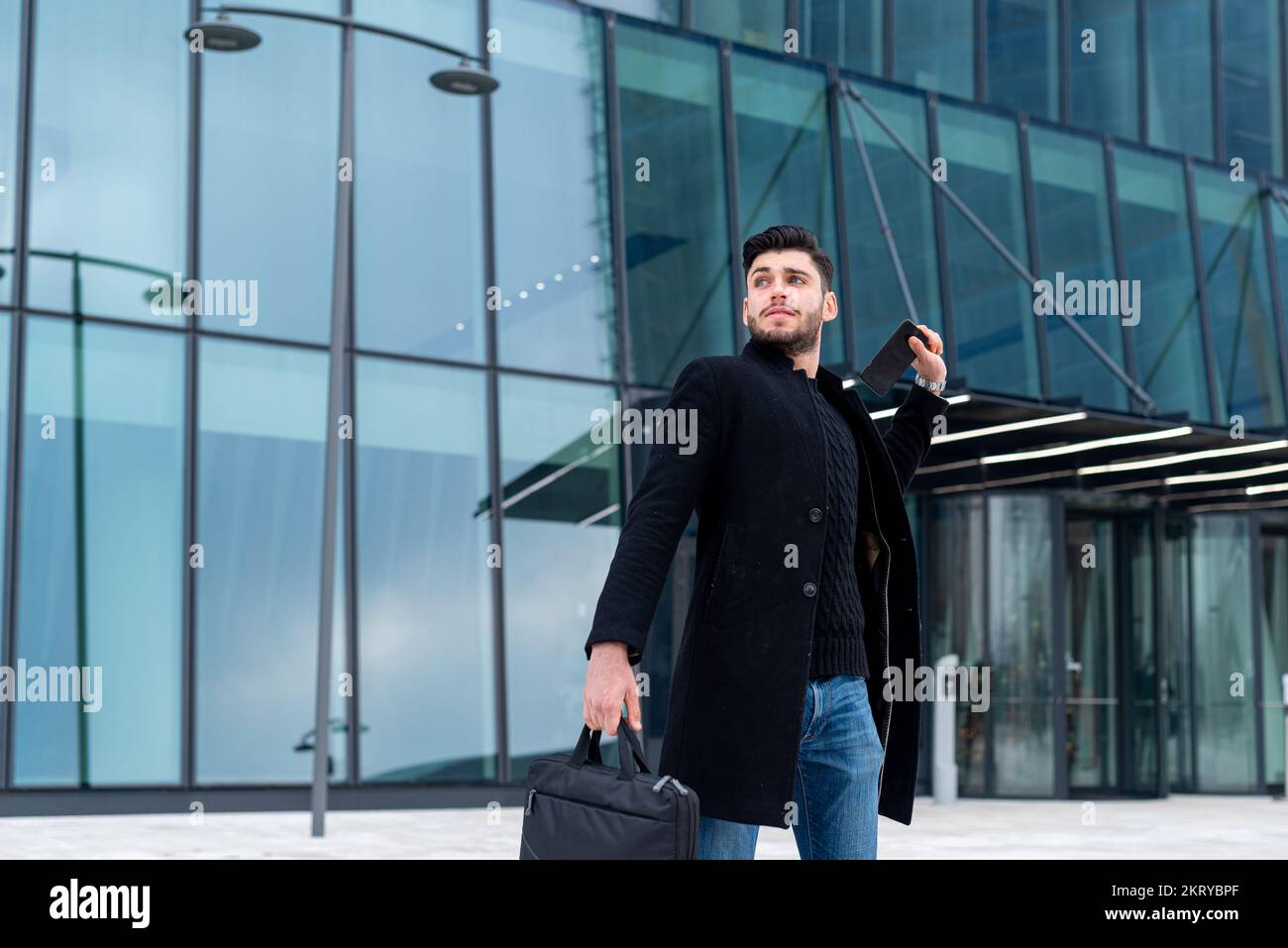 Young businessman is going to throw his cell phone in a fit of rage