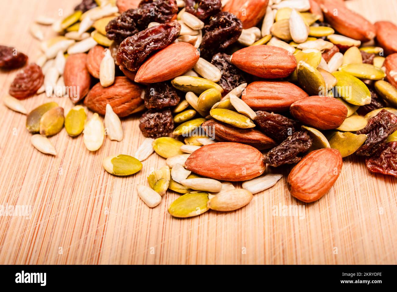 Closeup photo on raw organic nuts, seeds and dry fruit on wood surface. healthy eating snack Stock Photo