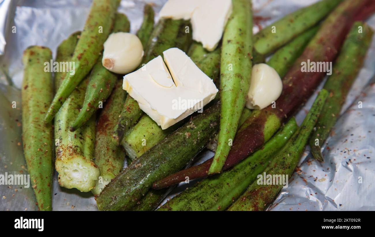 Grilled okra with garlic and melted butter in aluminum foil Stock Photo