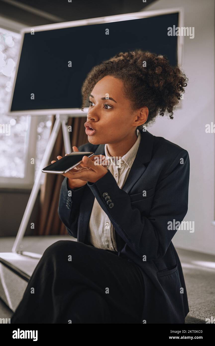 Woman speaking her thoughts on smartphone voice recorder Stock Photo