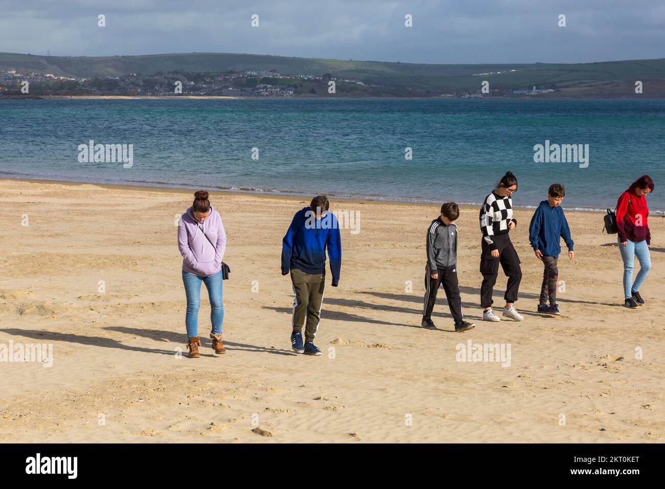 People walking along Weymouth beach at Weymouth, Dorset UK in October Stock Photo
