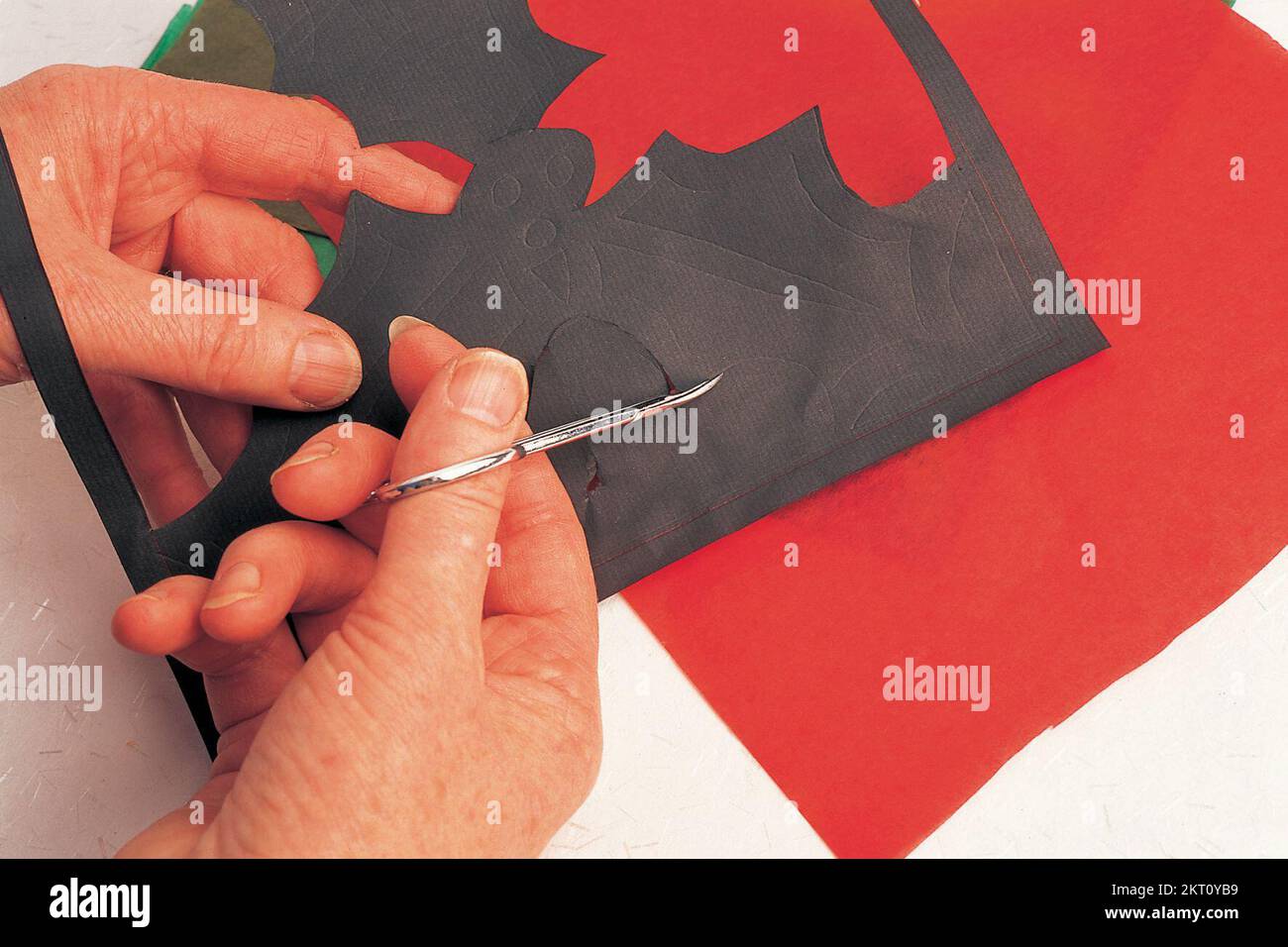 Cutting shapes out of black paper Stock Photo Alamy