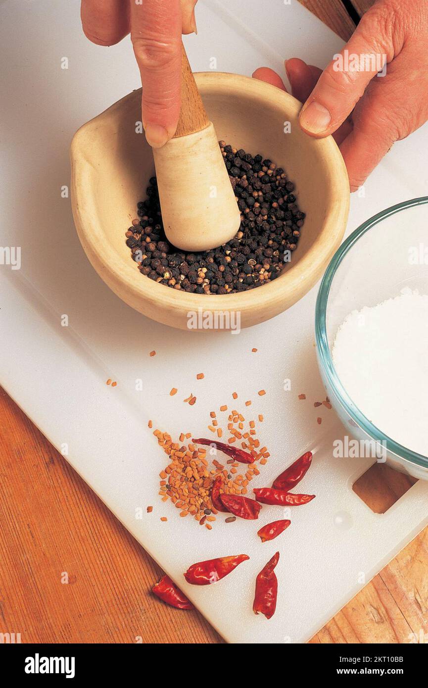 Grinding the spices in a mortar Stock Photo Alamy