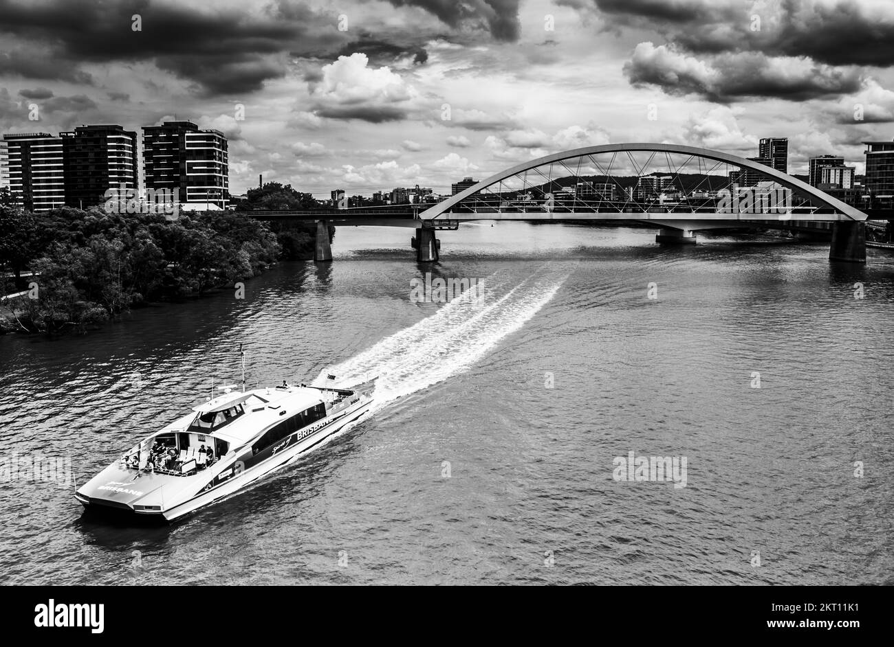Contrasted scene of metropolitan modernism with ferry boats and moody urban condition. Brisbane City, Queensland, Australia Stock Photo