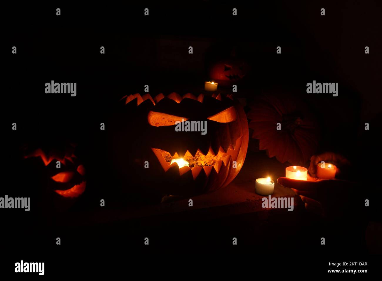 Carved halloween pumpkins glowing in the dark Stock Photo - Alamy
