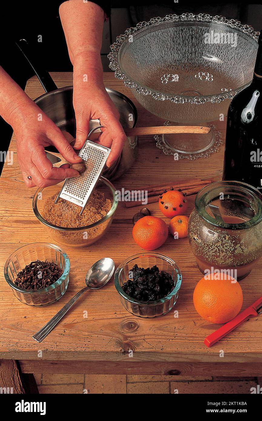 Grating the nutmeg using grater Stock Photo Alamy